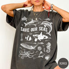 Comfort Colors tee in Pepper featuring line art marine life graphic with Save Our Seas text design