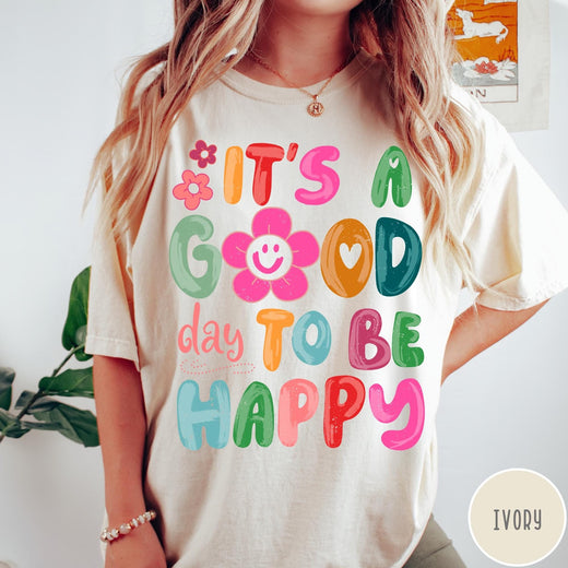 Comfort Colors tee in Ivory featuring typography and floral elements with a smiley face graphic design