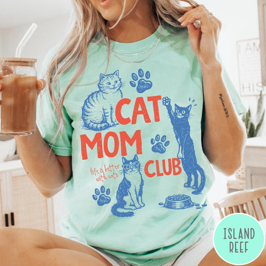 Comfort Colors tee in Island Reef featuring graphic illustration of cats, paw prints, and Cat Mom Club text