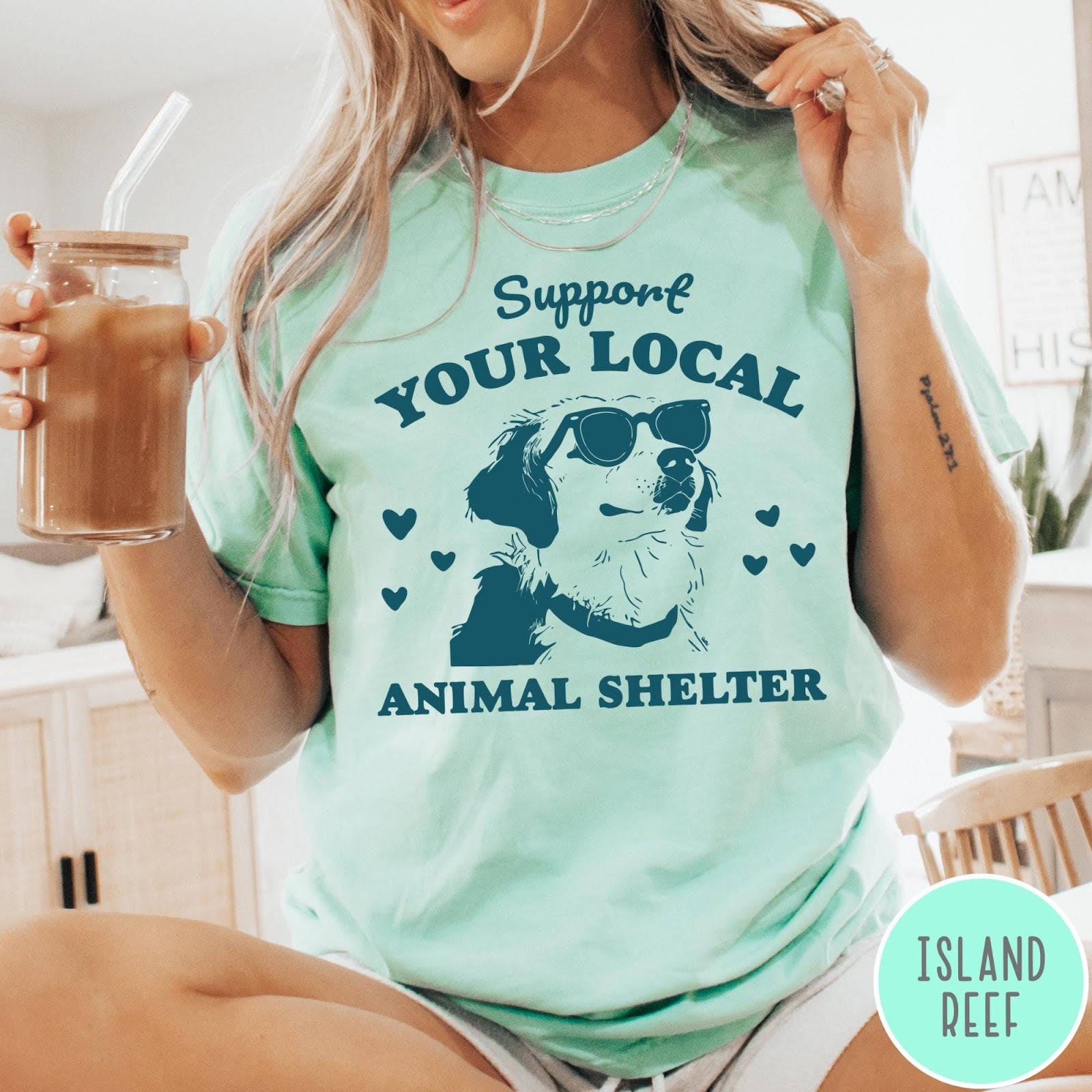 Comfort Colors tee in Island Reef featuring graphic illustration of a dog wearing sunglasses and surrounding small hearts
