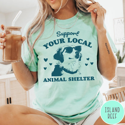 Comfort Colors tee in Island Reef featuring graphic illustration of a dog wearing sunglasses and surrounding small hearts