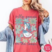 Comfort Colors tee in Watermelon featuring whimsical graphic style with a goose wearing a bonnet and floral border