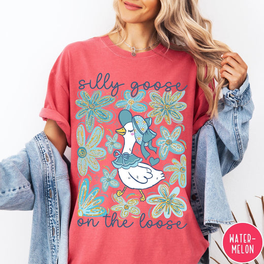 Comfort Colors tee in Watermelon featuring whimsical graphic style with a goose wearing a bonnet and floral border