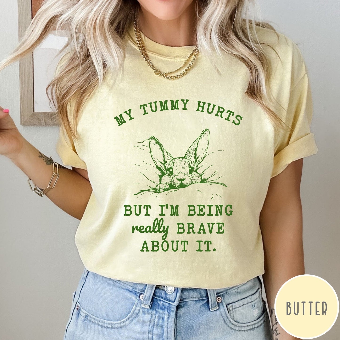 Comfort Colors tee in Butter featuring line art graphic of a bunny with text My Tummy Hurts