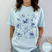 Comfort Colors tee in Chambray featuring space theme graphic with various dogs wearing astronaut helmets and planets