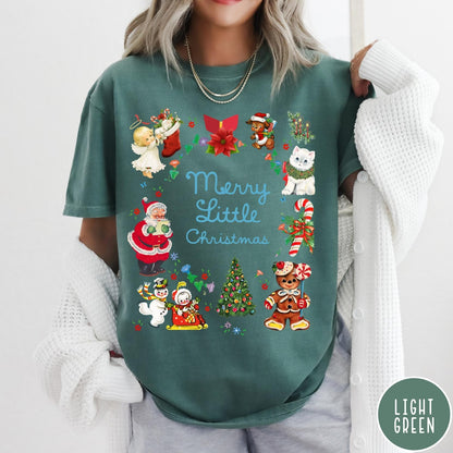 Comfort Colors tee in Light Green featuring vintage style holiday characters including Santa, a snowman, and gingerbread man.