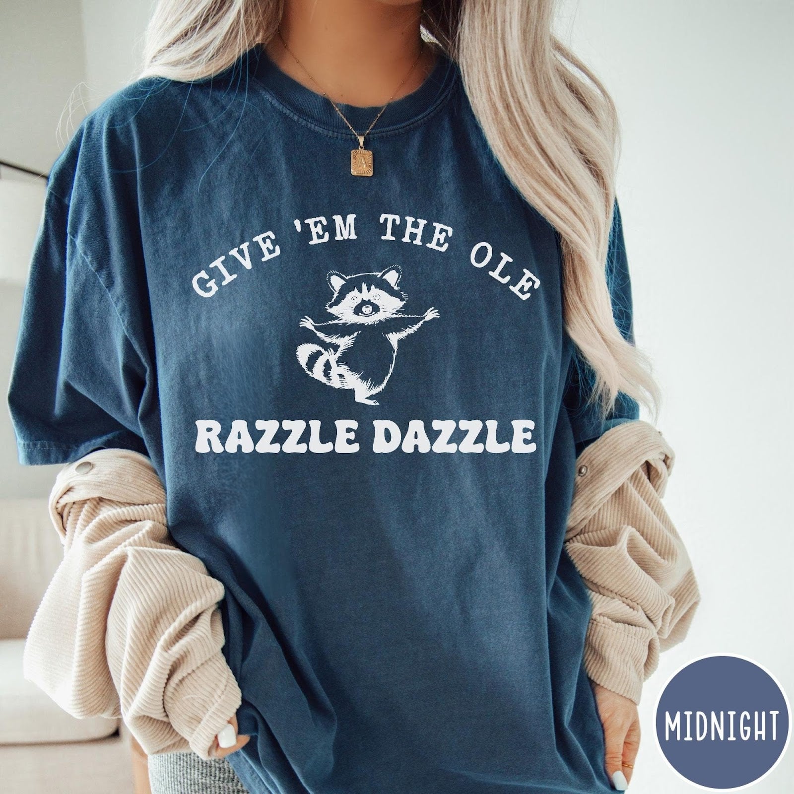 Comfort Colors tee in Midnight featuring whimsical raccoon graphic with Give Em The Ole Razzle Dazzle text