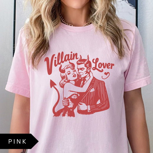 Comfort Colors tee in Pink featuring vintage style graphic of a devilish couple embracing with text Villain Lover