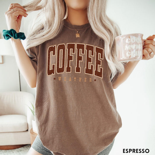 Comfort Colors tee in Espresso featuring collegiate style Coffee Weather graphic with distressed brown text and stars