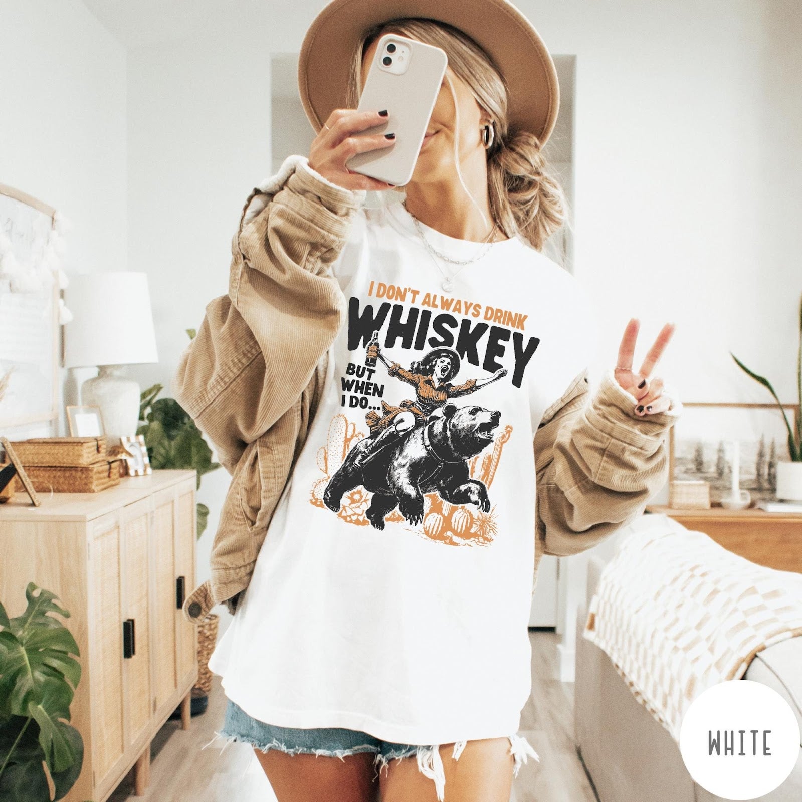 Comfort Colors tee in White featuring vintage style graphic of a woman riding a bear holding whiskey