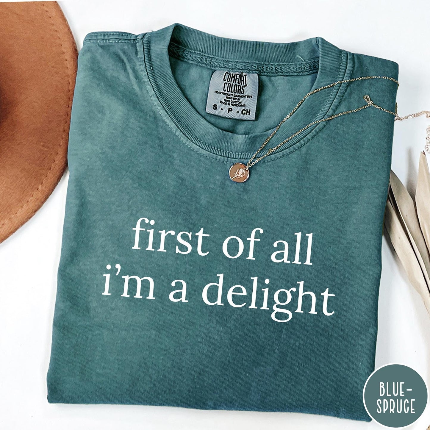 Comfort Colors tee in Blue Spruce featuring typography graphic reading first of all i'm a delight in white