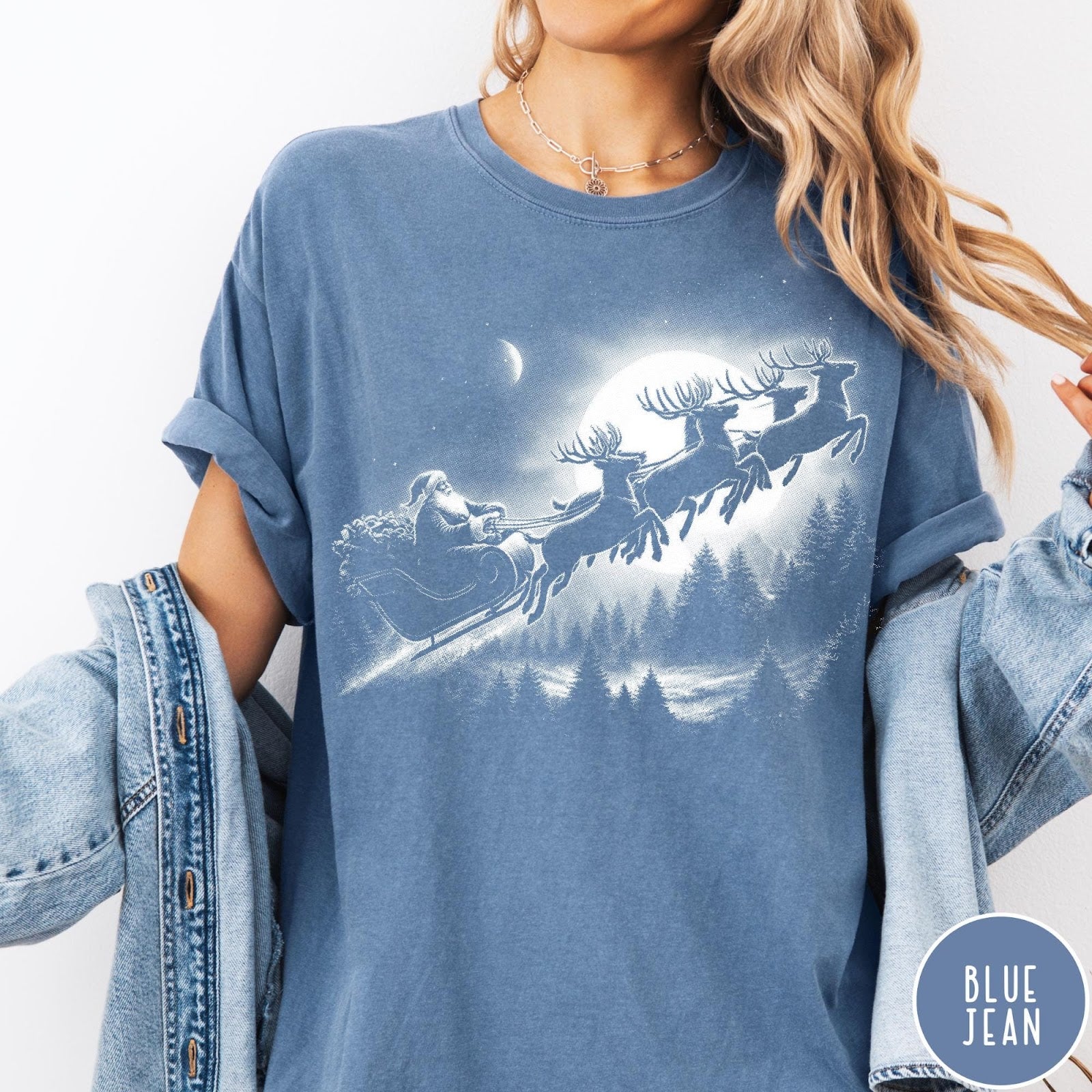Comfort Colors tee in Blue Jean featuring vintage style graphic of Santa Claus flying his sleigh with reindeer