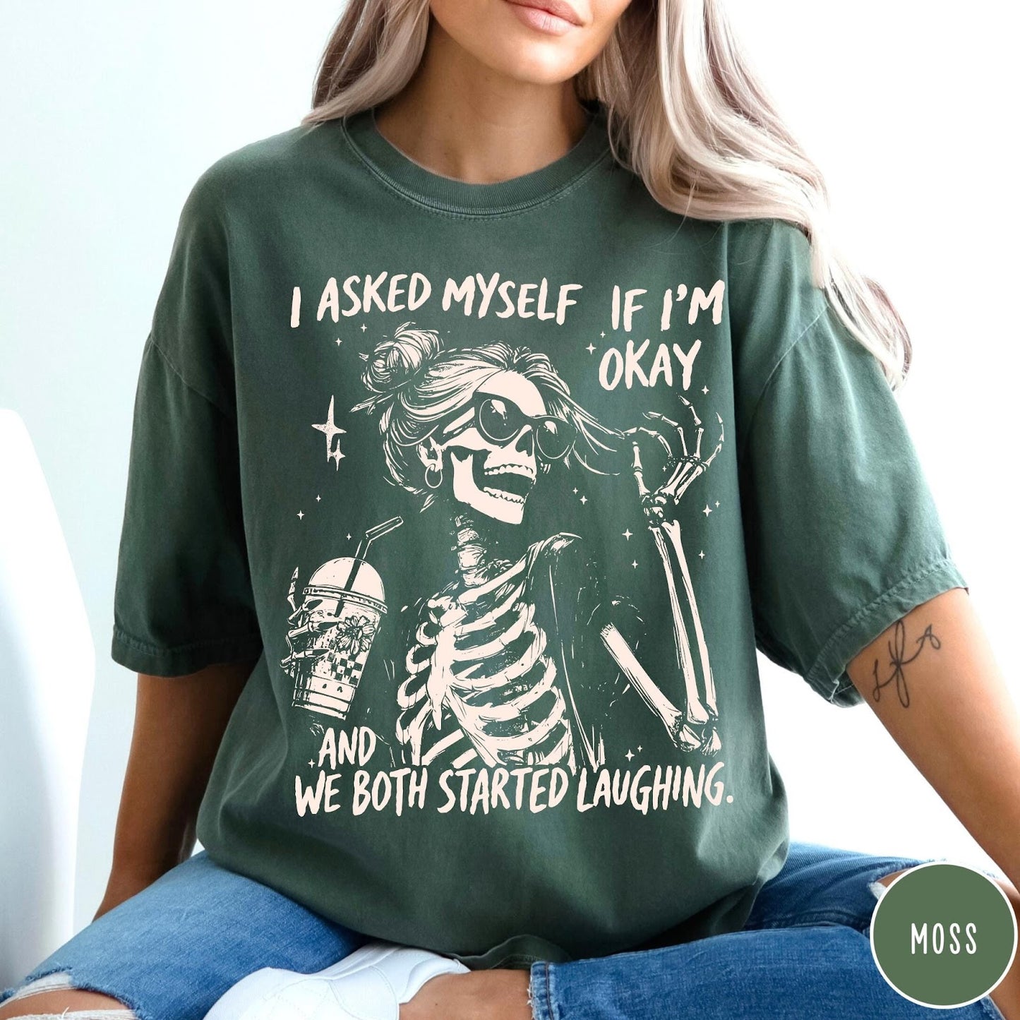 Comfort Colors tee in Moss featuring skeleton design with sunglasses and iced coffee with laughing text graphic