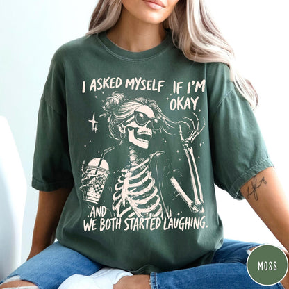 Comfort Colors tee in Moss featuring skeleton design with sunglasses and iced coffee with laughing text graphic
