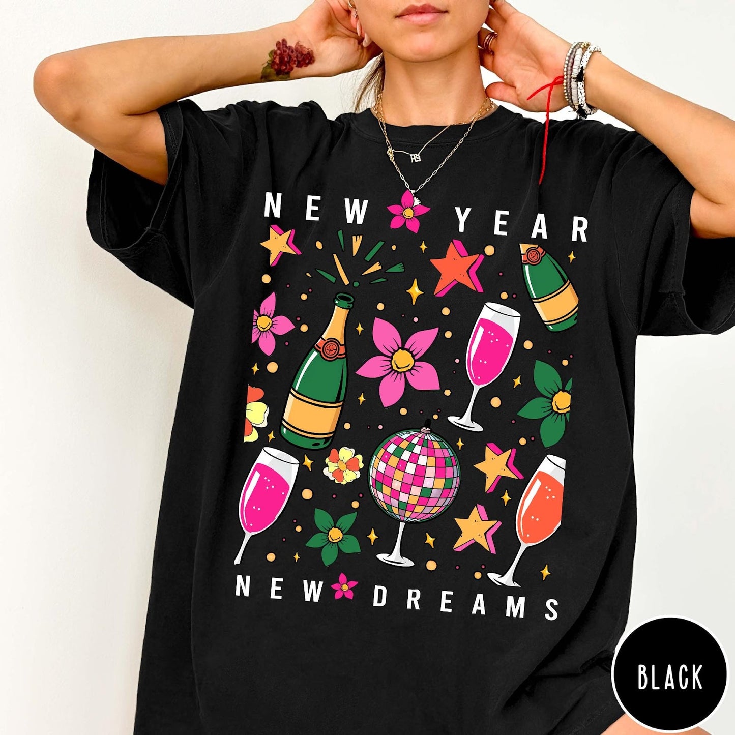 Comfort Colors tee in Black featuring New Year celebration graphic with champagne bottles, glasses, and disco ball
