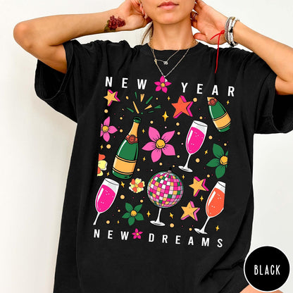 Comfort Colors tee in Black featuring New Year celebration graphic with champagne bottles, glasses, and disco ball