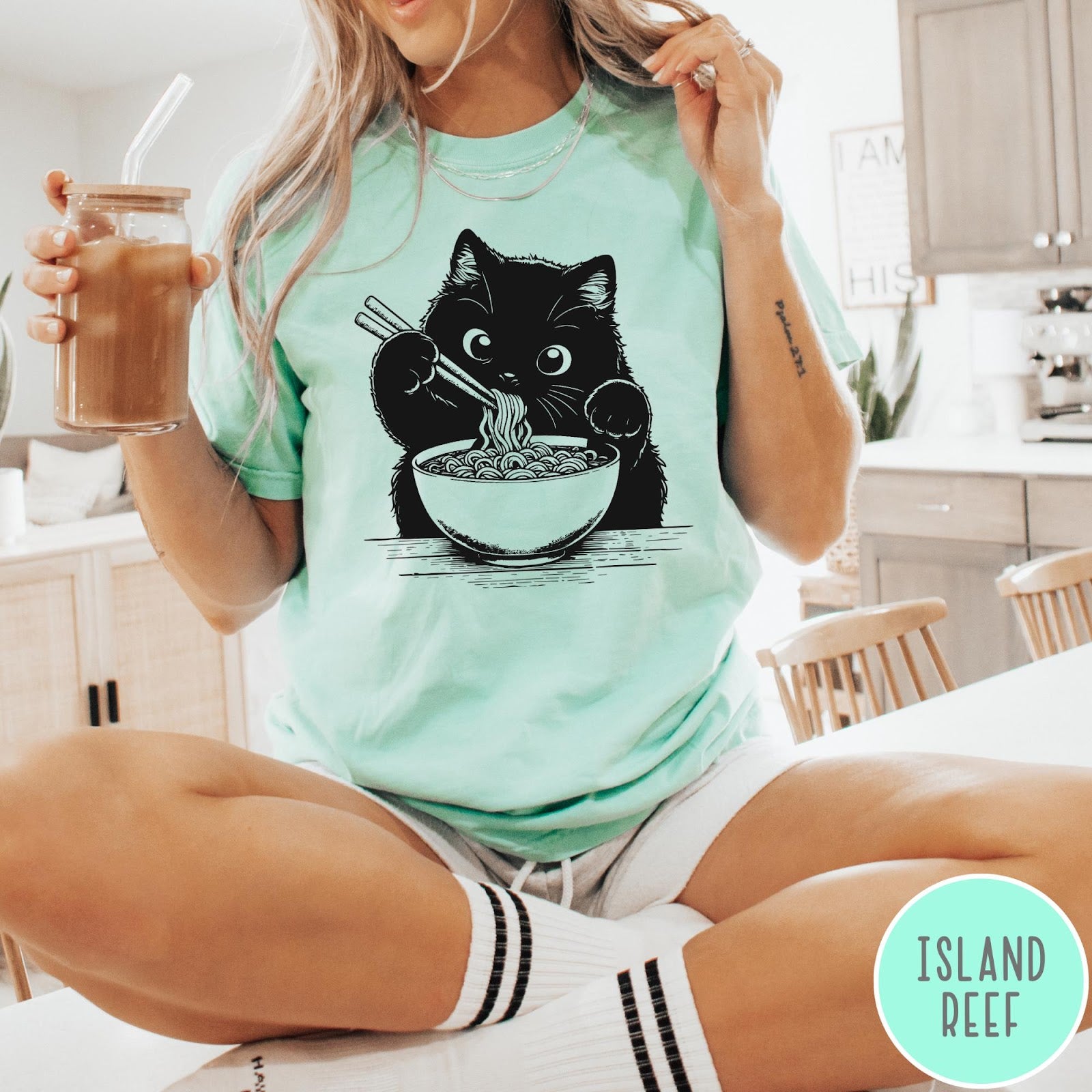 Comfort Colors tee in Island Reef featuring graphic illustration of a cute black cat eating a bowl of ramen