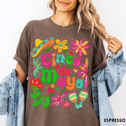 Comfort Colors tee in Espresso featuring festive Cinco de Mayo graphic with sombrero, maracas, and colorful flowers