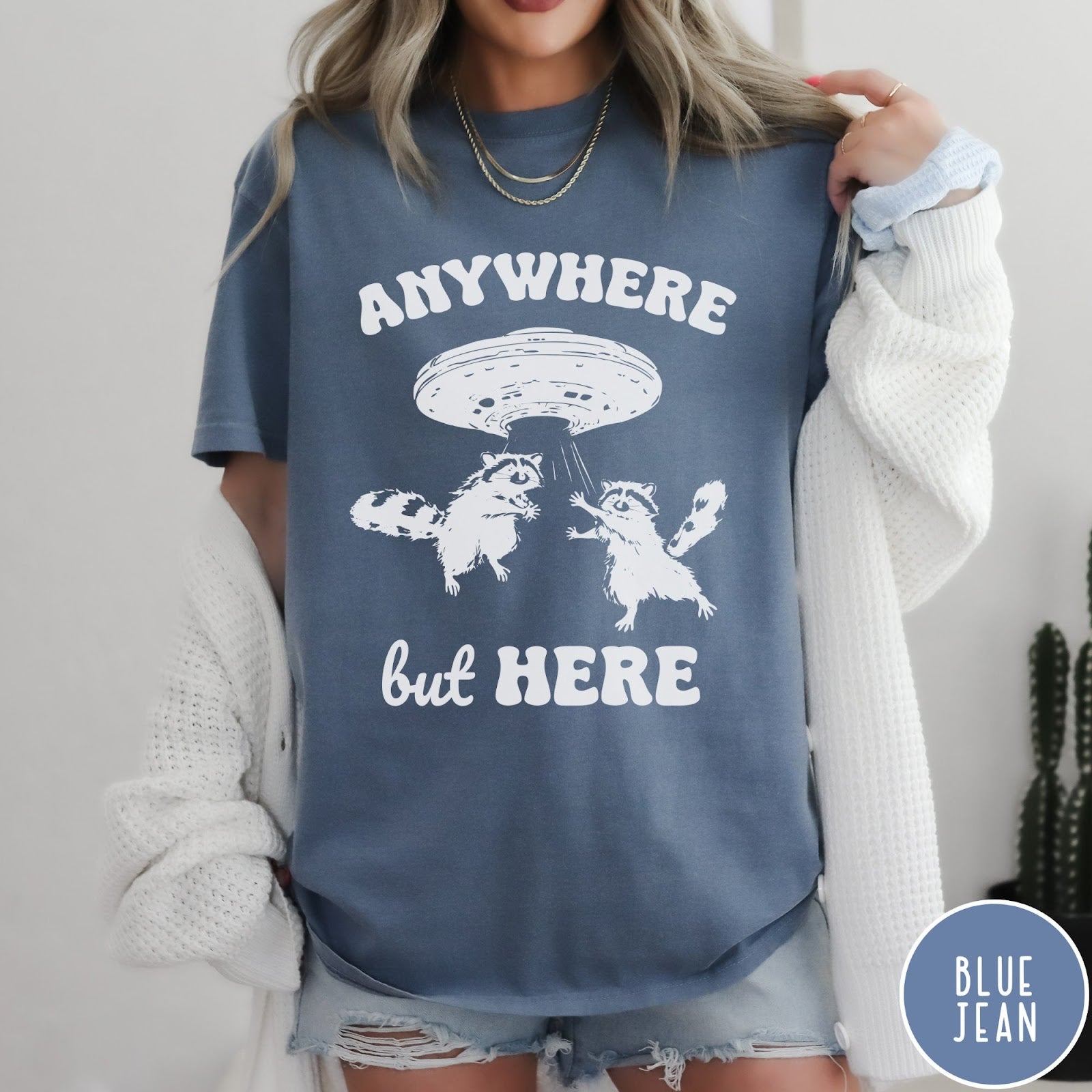 Comfort Colors tee in Blue Jean featuring whimsical graphic style with two raccoons being abducted by a UFO