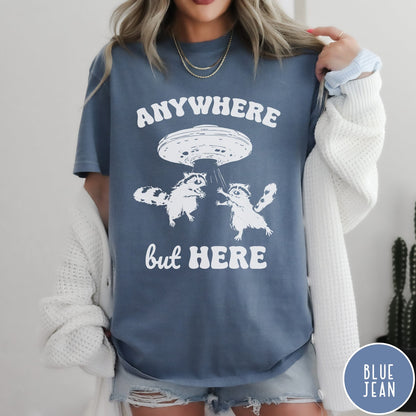 Comfort Colors tee in Blue Jean featuring whimsical graphic style with two raccoons being abducted by a UFO