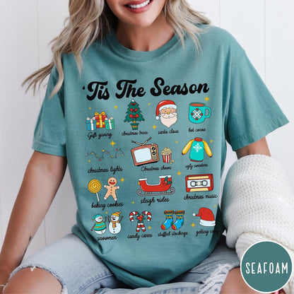 Comfort Colors tee in Seafoam featuring holiday icons graphic with Christmas trees, Santa, and festive seasonal imagery