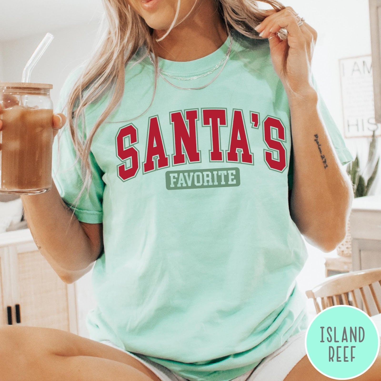Comfort Colors tee in Island Reef featuring collegiate style Santa's Favorite Christmas graphic with red and green text