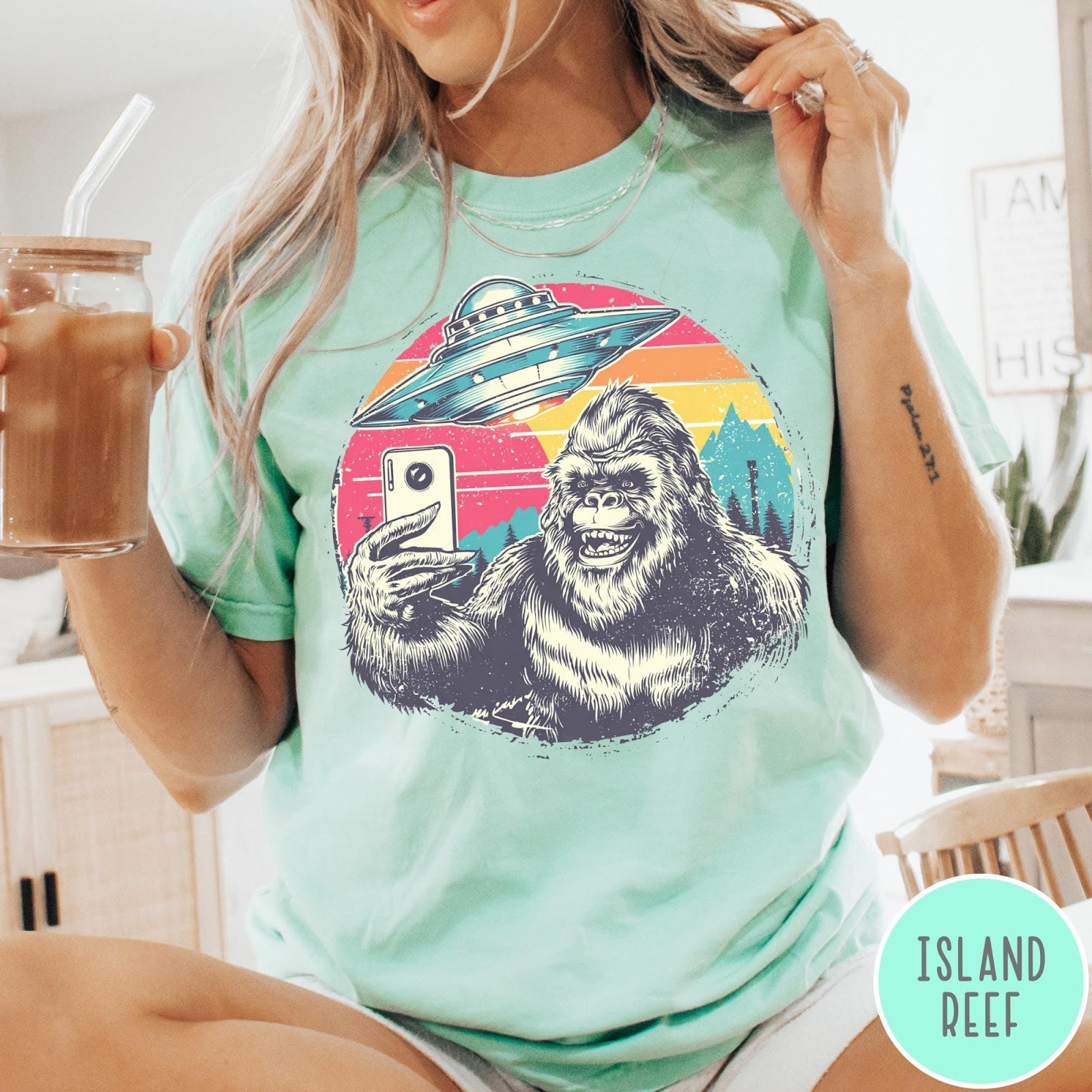Comfort Colors tee in Island Reef featuring retro graphic design of Bigfoot taking a selfie with a UFO