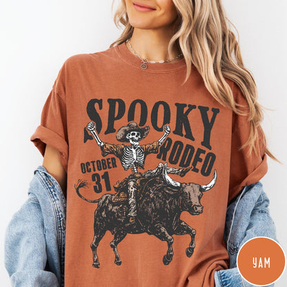 Comfort Colors tee in Yam featuring western style graphic of a skeleton cowboy riding a bucking bull