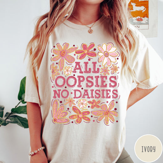 Comfort Colors tee in Ivory featuring floral design with funny quote All Oopsies No Daisies text graphic