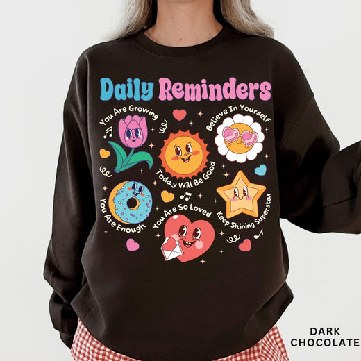 Comfort Colors tee in Dark Chocolate featuring retro mascot design with daily affirmations and colorful graphics