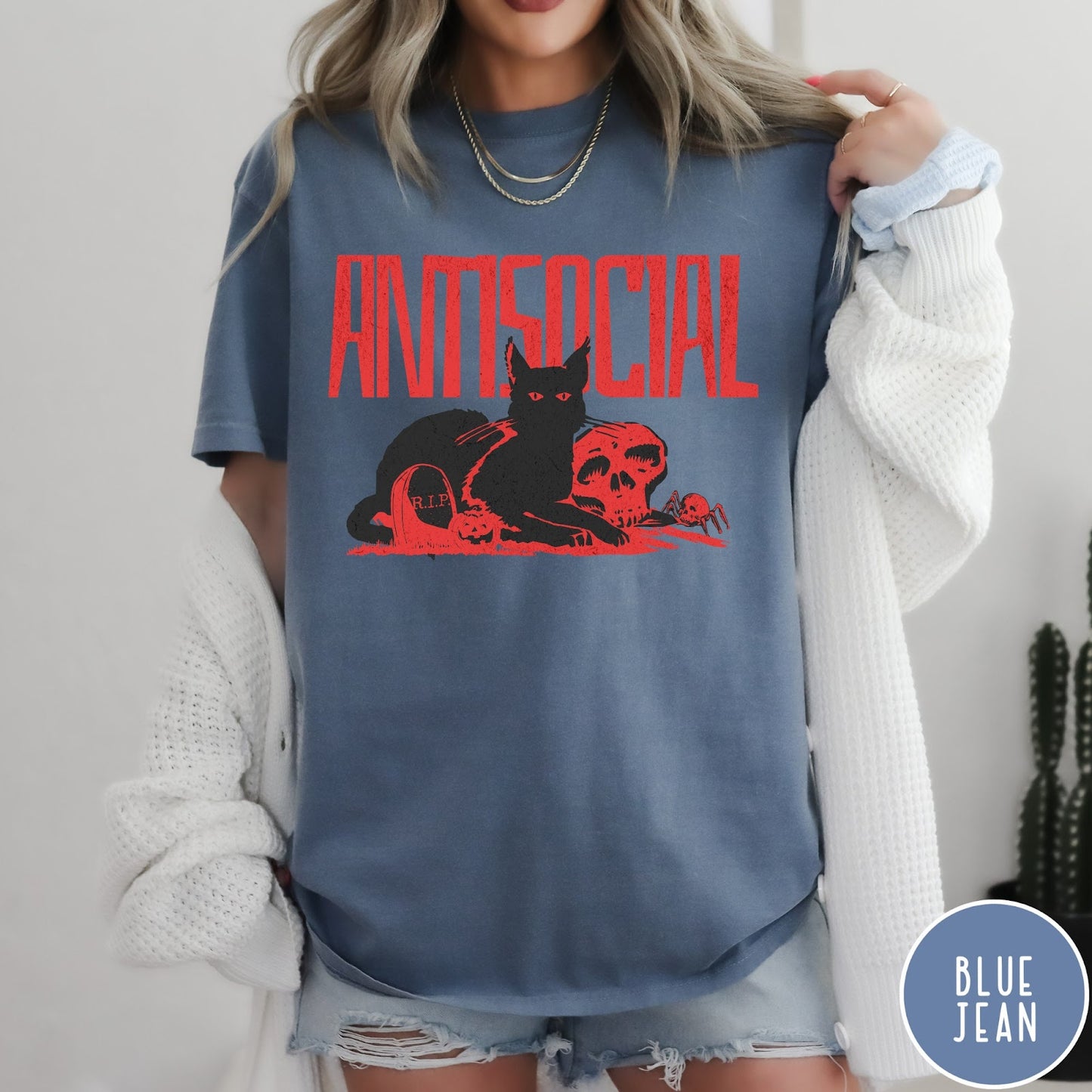 Comfort Colors tee in Blue Jean featuring retro graphic design of a black cat with skull and tombstone