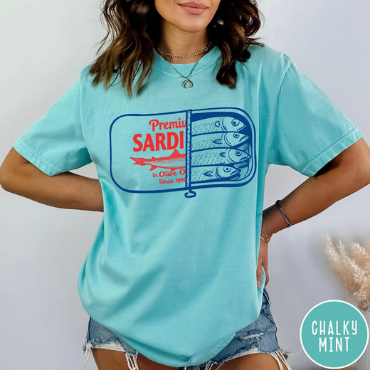 Comfort Colors tee in Chalky Mint featuring vintage style sardine tin graphic with red text and blue fish