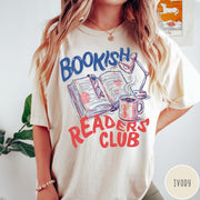 Comfort Colors tee in Ivory featuring illustrated book graphic with a lamp and a coffee mug design
