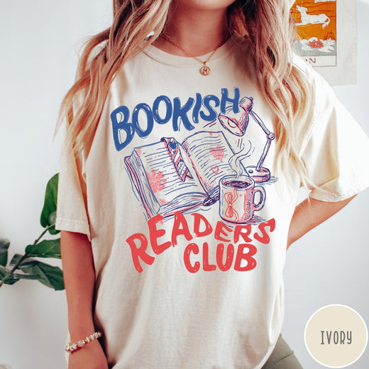 Comfort Colors tee in Ivory featuring illustrated book graphic with a lamp and a coffee mug design