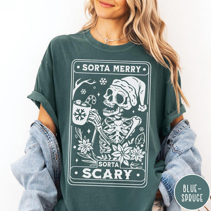 Comfort Colors tee in Blue Spruce featuring graphic design of a skeleton in a Santa hat holding cocoa