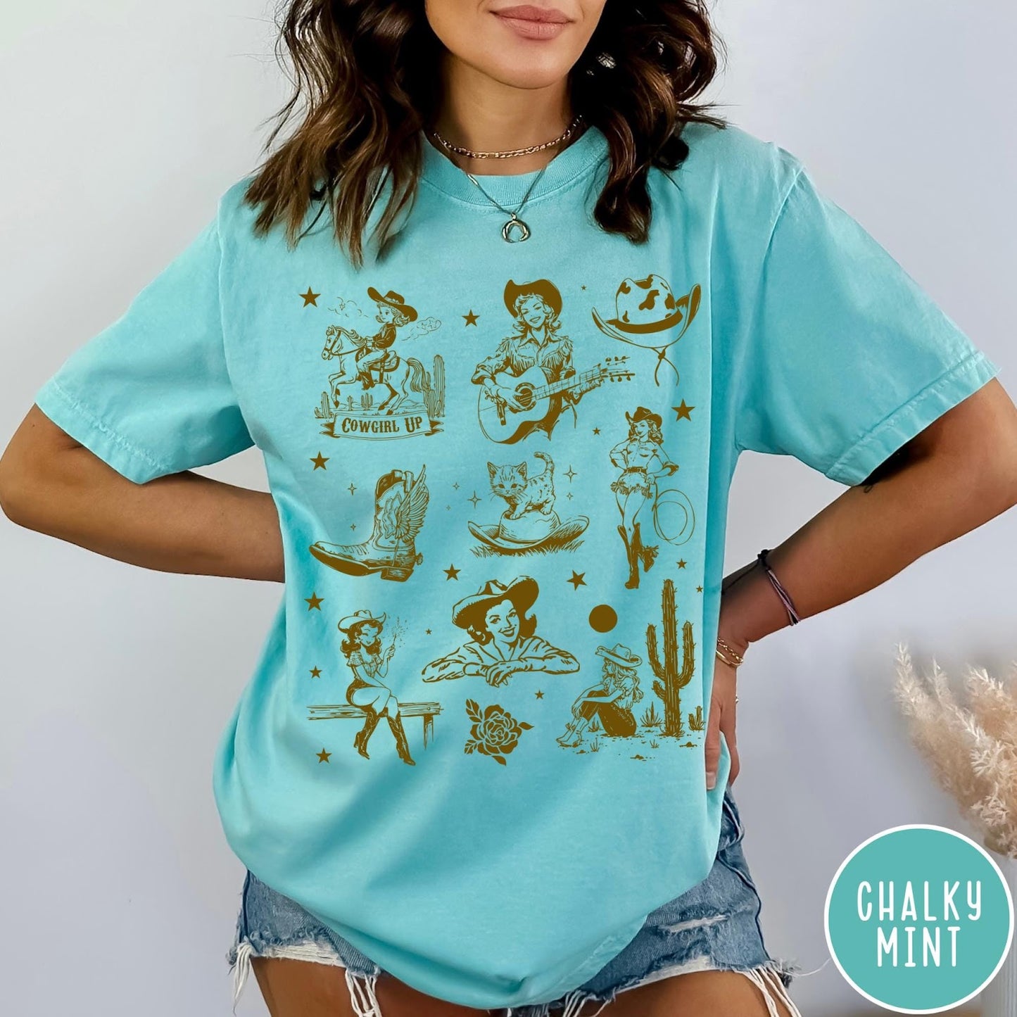 Comfort Colors tee in Chalky Mint featuring retro western collage graphic with cowgirls, boots, and desert elements