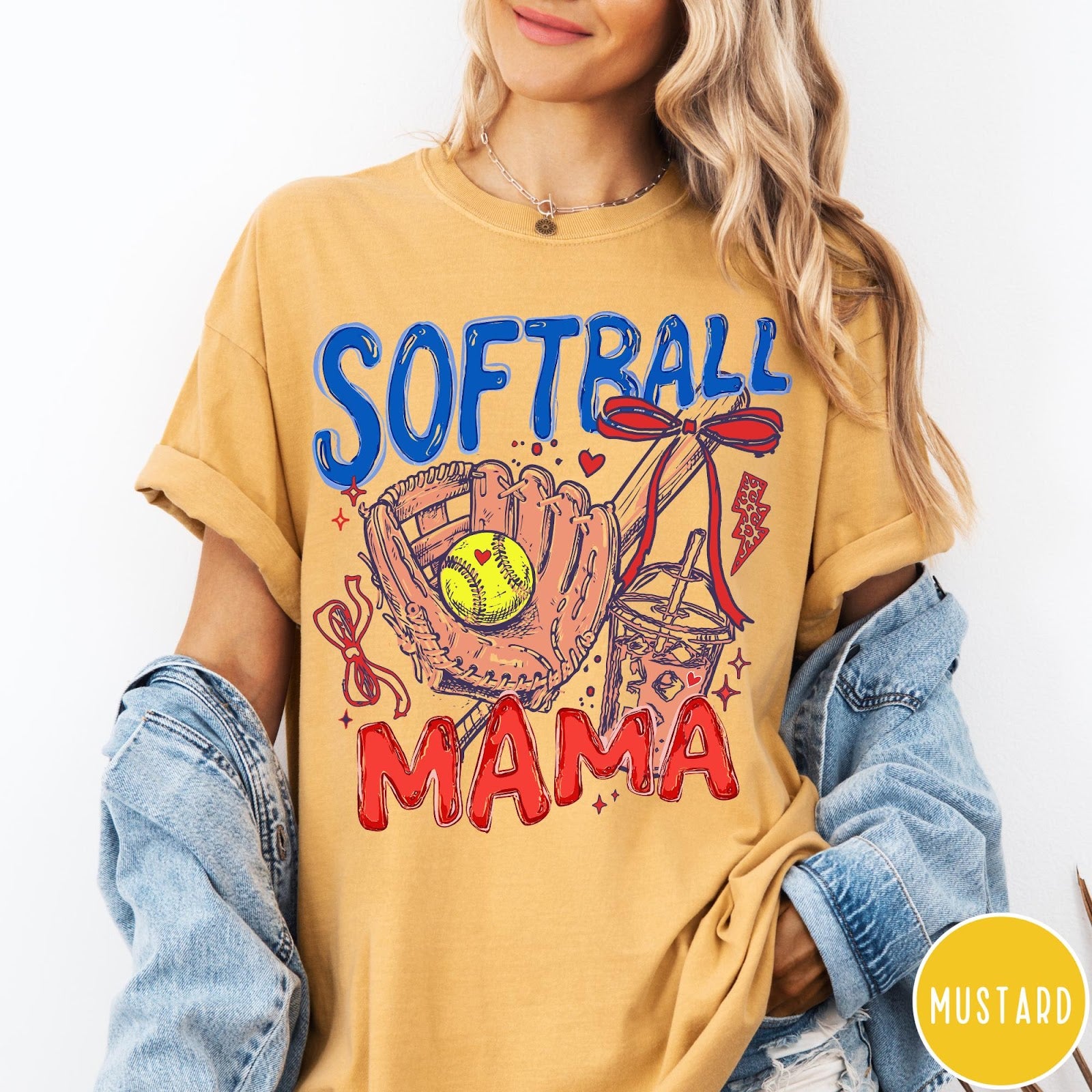 Comfort Colors tee in Mustard featuring softball mom graphic with glove, ball, bat, and iced coffee design