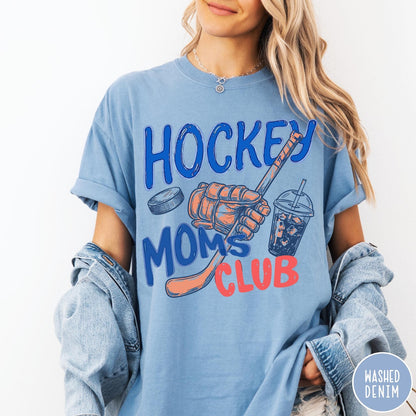 Comfort Colors tee in Washed Denim featuring hockey mom lifestyle graphic with hockey glove, puck, and drink