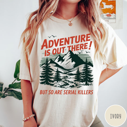 Comfort Colors tee in Ivory featuring mountain and tree graphic with adventure and serial killer text design