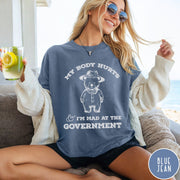 Comfort Colors tee in Blue Jean featuring line art style bear wearing a hat and button-up shirt graphic