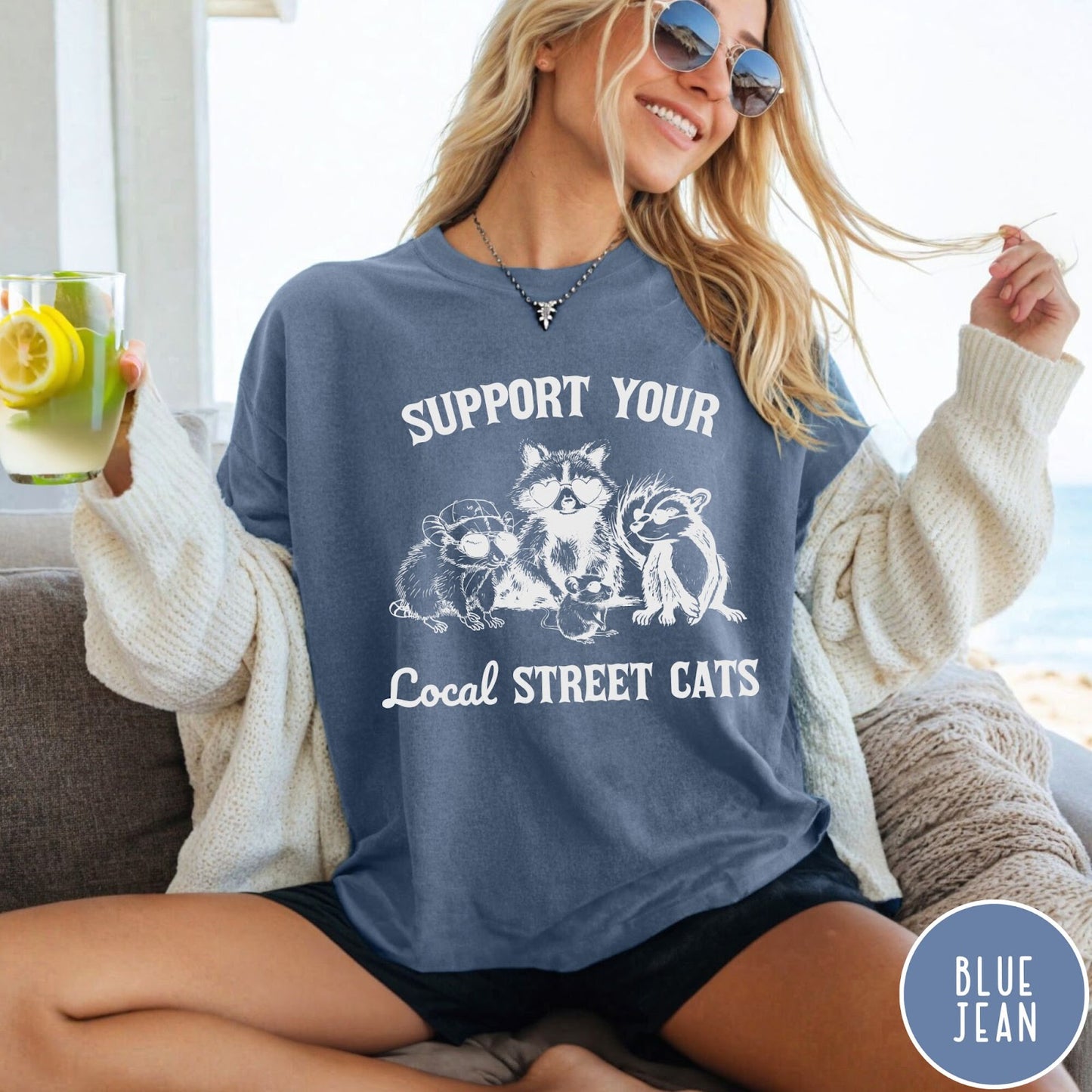 Comfort Colors tee in Blue Jean featuring illustration style graphic of a raccoon, opossum, and skunk wearing sunglasses
