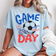 Comfort Colors tee in Chambray featuring soccer graphic with a ball, cleats, and Game Day text