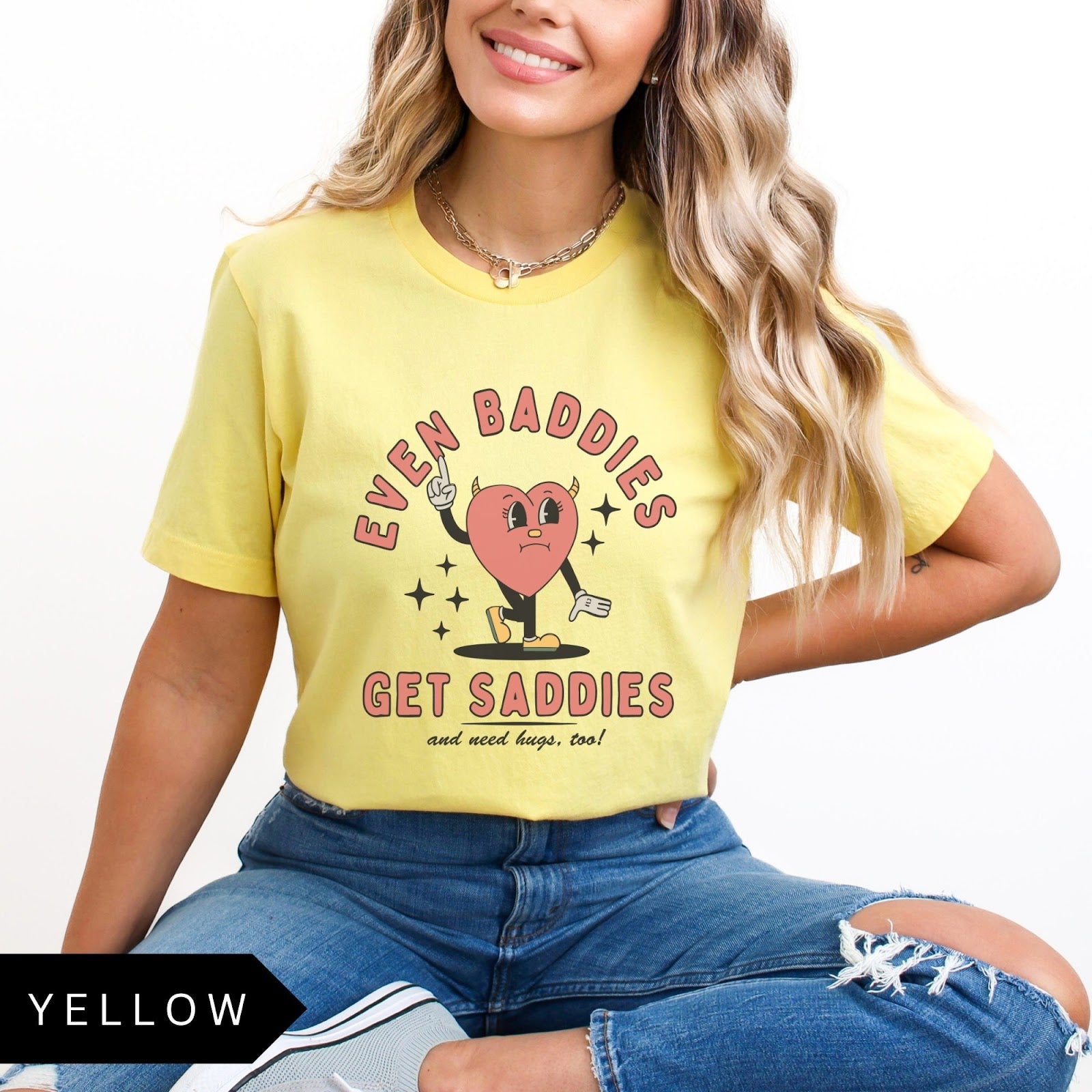Comfort Colors tee in Yellow featuring retro style sad heart character with horns and text graphic