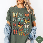 Comfort Colors tee in Moss featuring butterfly collection design with various colorful butterfly illustrations in a grid