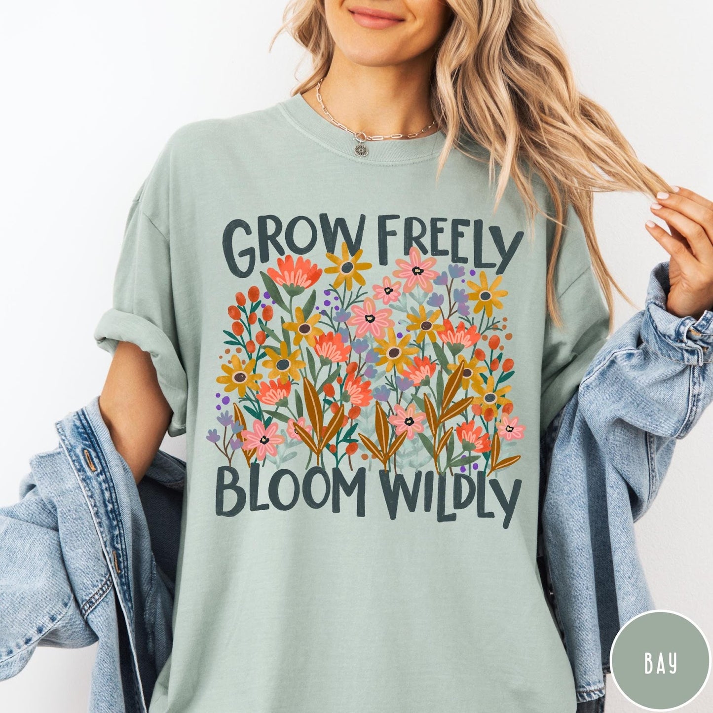 Comfort Colors tee in Bay featuring wildflower design with colorful flowers and Grow Freely Bloom Wildly text