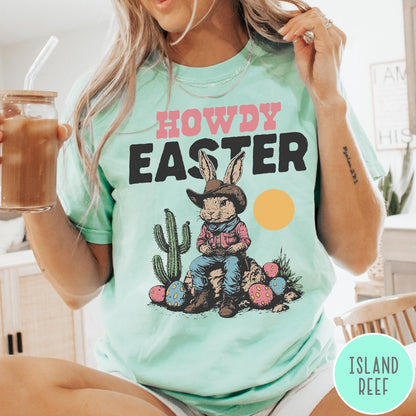 Comfort Colors tee in Island Reef featuring western design style cowboy bunny sitting on a rock with cactus