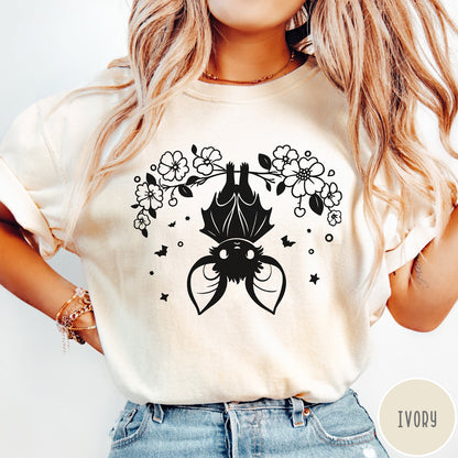 Comfort Colors tee in Ivory featuring line art style upside down bat graphic with surrounding floral elements