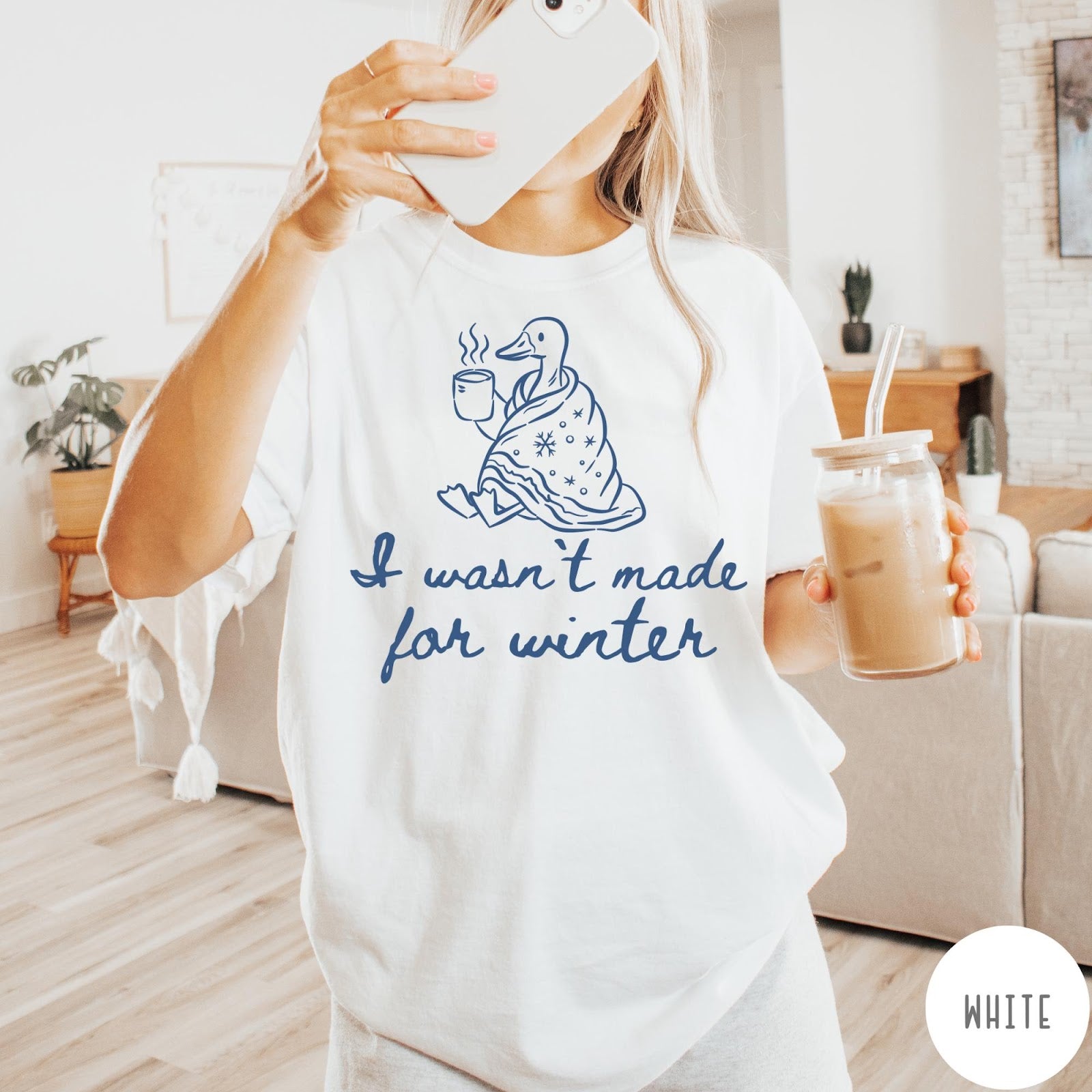 Comfort Colors tee in White featuring line art graphic of a duck wrapped in a blanket drinking coffee
