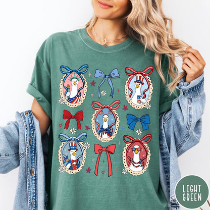 Comfort Colors tee in Light Green featuring coquette design with patriotic geese in frames and bows