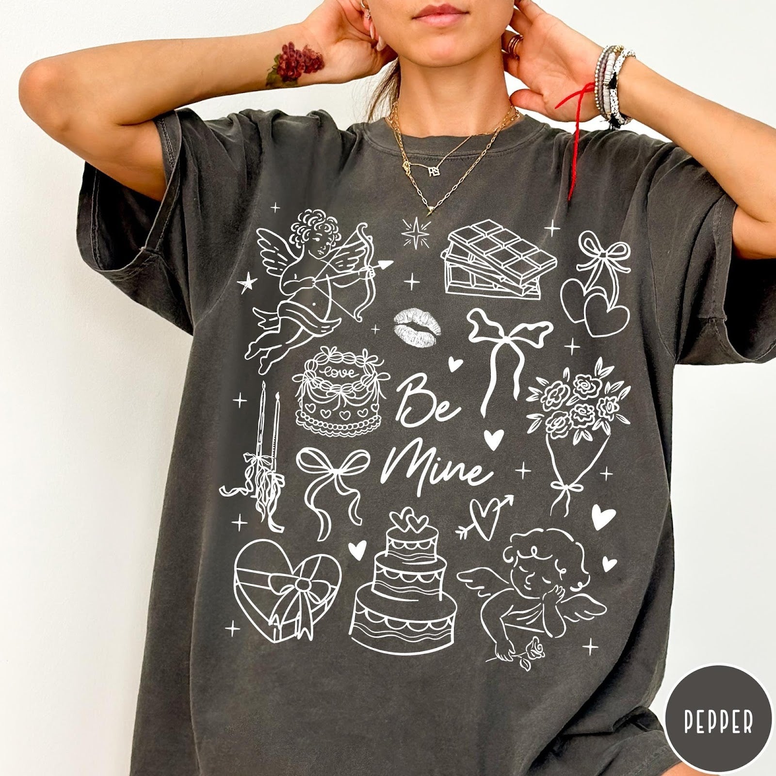 Comfort Colors tee in Pepper featuring Valentine's Day collage design with cupid, cake, flowers, and chocolate graphics